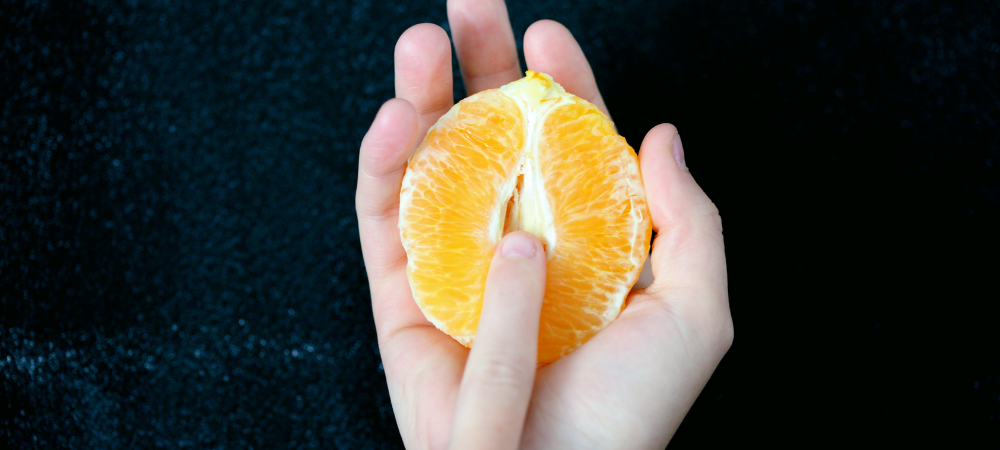 Hands caressing an orange