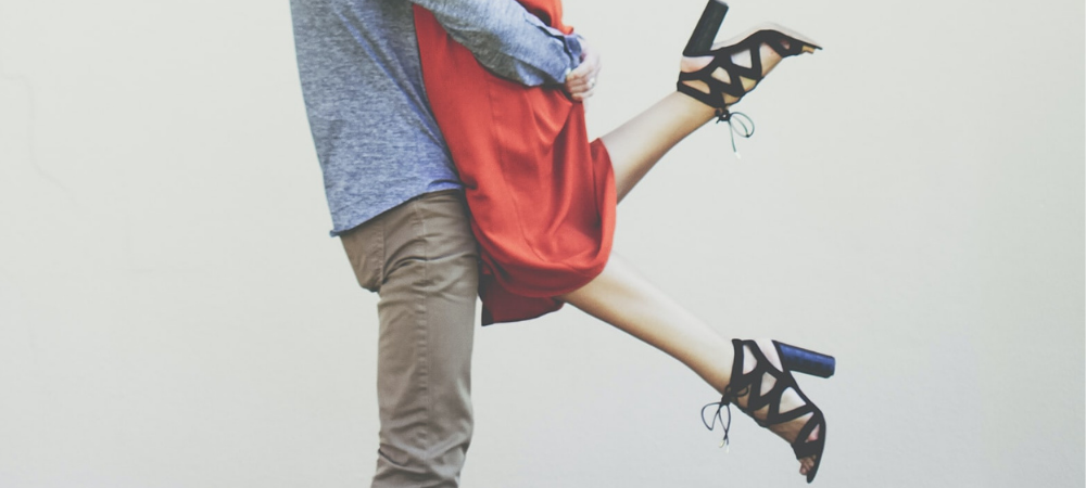 A man living a woman in a dress for an embrace